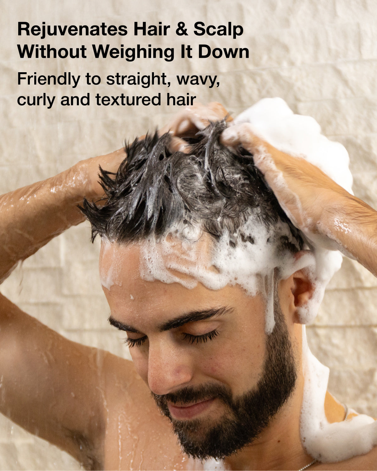 Man washing his hair with a shower curtain in the background