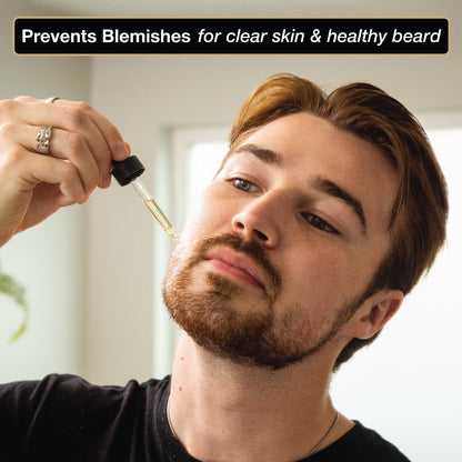 bearded model applying clarifying beard oil